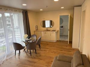 a living room with a table and chairs at Seaside apartments in Palanga