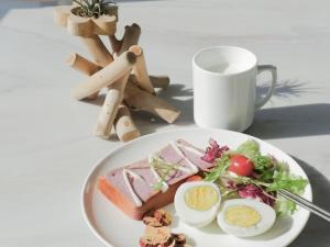 a plate of food with an egg and a salad at GreenTree Eastern Hotel Jiaxing Jiangnan Moore Store in Jiaxing