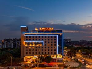 a large building with a sign on top of it at GreenTree Eastern Hotel Jiaxing Jiangnan Moore Store in Jiaxing