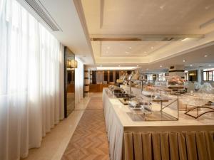 a restaurant with a buffet line in a building at GreenTree Eastern Hotel Lihu Yuantouzhu Scenic Area in Wuxi