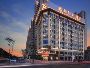 a large building with a sign on top of it at GreenTree Eastern Hotel Chuzhou Suchu Industrial Park in Chuzhou