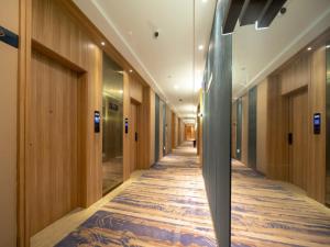 a hallway in a building with wooden walls and a long corridor at GreenTree Eastern Hotel Lihu Yuantouzhu Scenic Area in Wuxi