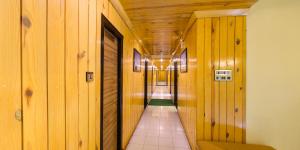 a hallway with wood paneling and a long corridor at Hotel Vishram in Mount Ābu