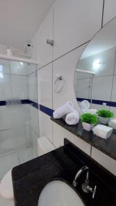 a bathroom with a sink and a shower and a mirror at JACY AP GOSTOSO in São Miguel do Gostoso +134 photos