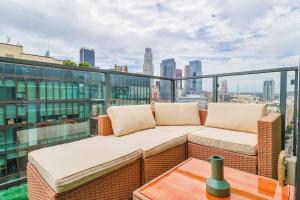 a balcony with a couch and a view of the city at Spectacular 3BDR & BTH in DTLA with pool, gym and balcony amazing views in Los Angeles