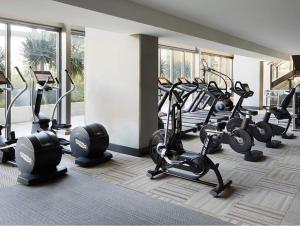 a gym with several treadmills and elliptical machines at Spectacular 3BDR & BTH in DTLA with pool, gym and balcony amazing views in Los Angeles