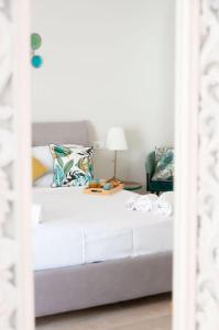 - une chambre avec un lit blanc et une table avec une lampe dans l'établissement Casa Dafne Sorrento Center, à Sorrente