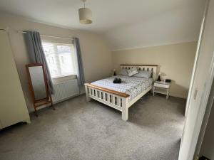 a bedroom with a bed with a cat sitting on it at Dovecote Lodge on the 5 star Lough Erne Resort in Ballycassidy