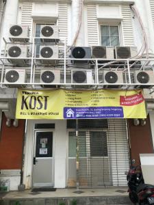 um sinal klost na lateral de um edifício em Bels Boarding House (Kost) em Pumpangsineng