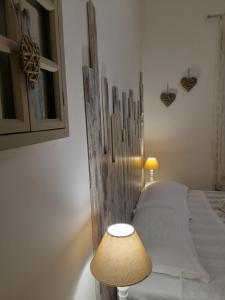 a bedroom with a bed with a lamp and a mirror at Il Mare Di Roma in Lido di Ostia