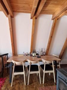 a dining room with two wooden tables and chairs at Green Eye in Žabljak