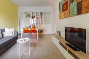 a living room with a couch and a table and a tv at Casa Limone by Wonderful Italy in Bologna