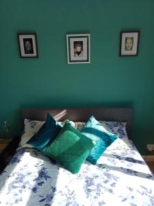 a bed with blue and white pillows on it at 32 station rd in Higham on the Hill