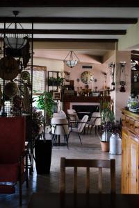 a room with a table and chairs and a dining room at Hotel Vila Bruci in Burrel