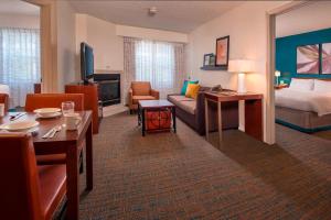 a hotel room with a bed and a living room at Residence Inn Fairfax Merrifield in Merrifield +21 photos