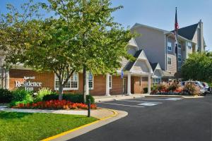 a hotel with a parking lot in front of a building at Residence Inn Fairfax Merrifield in Merrifield