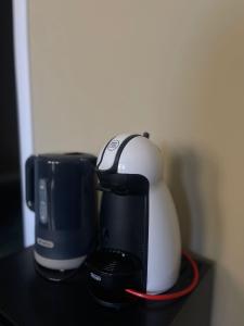 a coffee maker and a coffeemaker sitting on a table at B&B Piazza Duomo al 55 in Voghera +5 photos