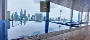 a swimming pool with a view of the city at KLCC Comfort Haven in Kuala Lumpur