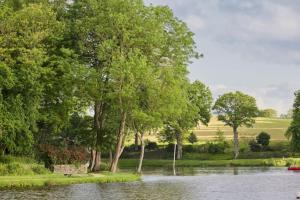 a body of water with trees and a river at La Villa Audren Love Room Jacuzzi in Châtelaudren