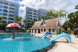 a swimming pool with slides and a playground at Heeton Concept Hotel Pattaya by Compass Hospitality in Pattaya Central
