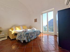 a bedroom with a bed and a large window at La casa di Enzo in Capri