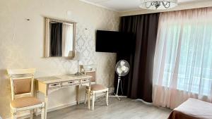 a bedroom with a desk and a bed with a window at Paradise in Tampere