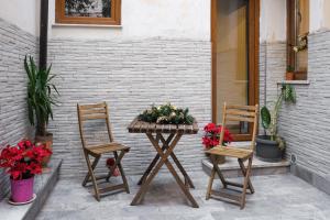 2 sillas y una mesa con flores en el patio en Piagentina Residence 1 en Florence