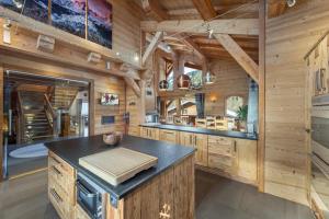 a kitchen with wooden walls and a stove in a cabin at Chalet Carnauba in Châtel