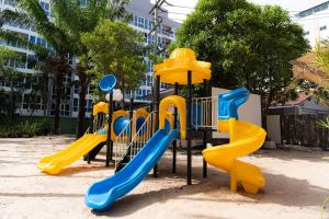 a playground with yellow and blue slides at Heeton Concept Hotel Pattaya by Compass Hospitality in Pattaya