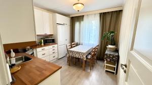 a kitchen with a table and a dining room at Paradise in Tampere