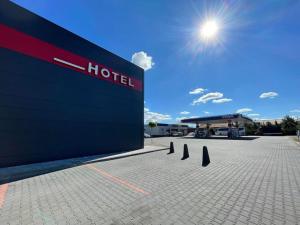 a hotel sign in front of a building at M&W Hotel Wronowski in Łomża