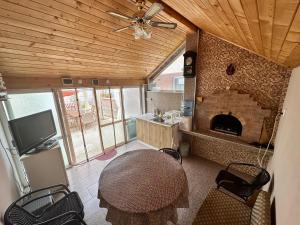 a living room with a table and a fireplace at При Наско in Shabla