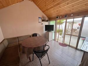 a room with a table and a couch and a television at При Наско in Shabla +5 photos