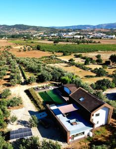 an aerial view of a house with a tennis court at Quinta da Sra Marocas in Covilhã