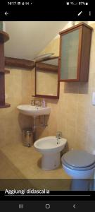 a bathroom with a sink and a toilet at Amelia in Menton