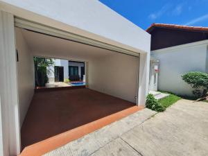 a garage with an open door to a house at Blu Village Pool Villa in Bang Tao Beach