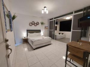a large bedroom with a bed and a bathroom at Bonsai Jacuzzi Suites in Panglao