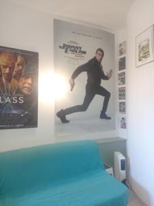 a room with a movie poster and a bed at Amelia in Menton