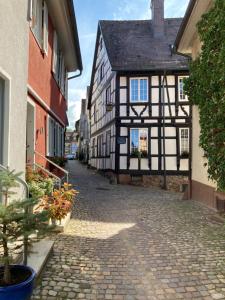 a cobblestone street in a medieval town with buildings at Ferienwohnung Scheffelhaus in Gengenbach