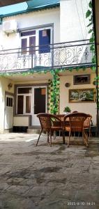 a patio with a table and chairs in front of a building at Nur-Niso Guest House in Bukhara