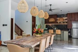 a dining room with a wooden table and chairs at Villa Yasmin in Seminyak