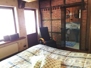 a bedroom with a bed and a brick wall at Ferienhaus zum Schornsteinfeger in Bad Bevensen