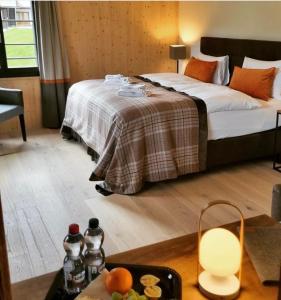 a hotel room with a bed and a tray of food at Eiger View Alpine Lodge in Grindelwald