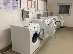 a row of washing machines in a laundry room at Ferienwohnung Schwarzwald Oase Kniebis in Kniebis