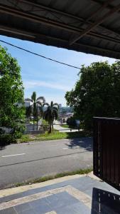 una calle vacía con palmeras a un lado de la carretera en Aaira Sophea Islamic Homestay en Batu Pahat