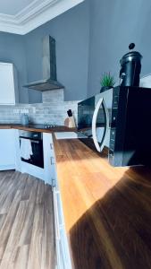 a kitchen with a wooden floor and a counter top at The King's Tower in Whitehead