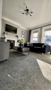 a living room with a couch and a fireplace at The King's Tower in Whitehead