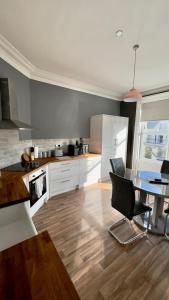 a kitchen with a table and a dining room at The King's Tower in Whitehead