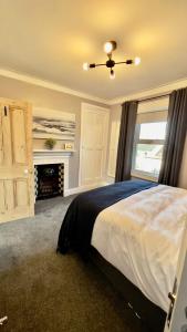 a bedroom with a large bed and a fireplace at The King's Tower in Whitehead