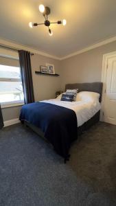 a bedroom with a large bed with a ceiling fan at The King's Tower in Whitehead